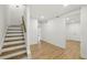 Bright, newly renovated hallway with wood floors and stairs at 12230 Asbury Park Dr, Roswell, GA 30075