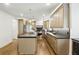 Gourmet kitchen featuring stone countertops, hardwood floors, and pendant lighting at 12230 Asbury Park Dr, Roswell, GA 30075