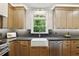 Bright kitchen featuring stone countertops, farm sink, stainless appliances and modern cabinets at 12230 Asbury Park Dr, Roswell, GA 30075