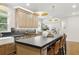 Kitchen boasts an island with seating, stainless appliances, and great natural light at 12230 Asbury Park Dr, Roswell, GA 30075