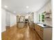 Open concept kitchen with large island, hardwood flooring and stainless steel appliances at 12230 Asbury Park Dr, Roswell, GA 30075