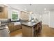 Kitchen features island with bar seating, stainless appliances, and farm sink at 12230 Asbury Park Dr, Roswell, GA 30075