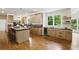 Spacious kitchen with a center island, bright cabinets and stainless steel appliances at 12230 Asbury Park Dr, Roswell, GA 30075