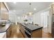 Open kitchen featuring a center island, modern appliances, and sleek countertops at 12230 Asbury Park Dr, Roswell, GA 30075