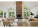 Living room with a stone fireplace, cathedral ceiling, hardwood floors and lots of natural light at 12230 Asbury Park Dr, Roswell, GA 30075