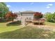 Spacious backyard features a deck and mature trees, perfect for outdoor entertaining and relaxation at 129 Crown Walk, Mcdonough, GA 30253