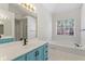 Bathroom vanity with soaking tub and large window at 129 Crown Walk, Mcdonough, GA 30253
