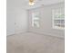 Clean and bright bedroom with neutral carpet, two windows, and a ceiling fan at 129 Crown Walk, Mcdonough, GA 30253