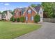 Charming brick home with blue shutters, a long driveway, and manicured bushes offers a welcoming exterior at 129 Crown Walk, Mcdonough, GA 30253