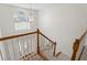 Entryway view showcasing the staircase with wood railing, a window, and front door at 129 Crown Walk, Mcdonough, GA 30253