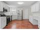 Spacious kitchen with stainless steel appliances, white cabinetry, and terracotta tile flooring at 129 Crown Walk, Mcdonough, GA 30253