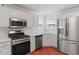 Kitchen featuring stainless steel appliances and terracotta flooring at 129 Crown Walk, Mcdonough, GA 30253