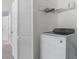Laundry room with a full-sized washing machine and wire shelving at 129 Crown Walk, Mcdonough, GA 30253