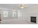 Large living room with neutral carpet, a fireplace, crown molding, and multiple windows for abundant natural light at 129 Crown Walk, Mcdonough, GA 30253