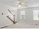 Inviting living space with plush carpet, staircase, and ample natural light, perfect for relaxation and entertainment at 129 Crown Walk, Mcdonough, GA 30253