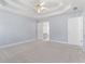 Main bedroom with neutral carpet, ceiling fan and ensuite bathroom at 129 Crown Walk, Mcdonough, GA 30253