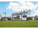 Large backyard with lush green grass featuring a view of the house with a covered patio at 3735 Tamiami Trl, Cumming, GA 30041