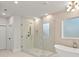 Bathroom with glass shower, decorative tile, rain shower head and soaking tub at 3735 Tamiami Trl, Cumming, GA 30041