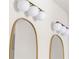 Close-up of round mirrors over a white vanity with matching globe lights in a spacious bathroom at 3735 Tamiami Trl, Cumming, GA 30041