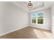 Neutral bedroom with light hardwood floors, recessed lights and a double window providing natural light at 3735 Tamiami Trl, Cumming, GA 30041