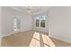 Bright bedroom with light hardwood floors, a tray ceiling, recessed lights and a double window at 3735 Tamiami Trl, Cumming, GA 30041