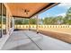 Spacious covered patio with a wood ceiling, ceiling fan, concrete floor, and backyard views at 3735 Tamiami Trl, Cumming, GA 30041