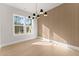 The dining room features elegant lighting, textured walls, and beautiful hardwood floors at 3735 Tamiami Trl, Cumming, GA 30041