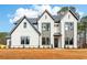 Beautiful modern two-story home with light brick, dark trim, and manicured landscaping on a sunny lot at 3735 Tamiami Trl, Cumming, GA 30041