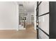 Bright foyer featuring light wood flooring, a modern staircase, and black framed glass front door at 3735 Tamiami Trl, Cumming, GA 30041