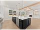 Beautiful open kitchen featuring a large island, modern appliances, and hardwood flooring at 3735 Tamiami Trl, Cumming, GA 30041