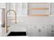 Bright kitchen features a modern design with a gold faucet and white countertops at 3735 Tamiami Trl, Cumming, GA 30041