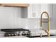 Bright kitchen features a modern gas cooktop and white countertops at 3735 Tamiami Trl, Cumming, GA 30041