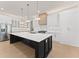 Modern kitchen features a large center island, white cabinetry, stainless steel appliances, and pendant lighting at 3735 Tamiami Trl, Cumming, GA 30041