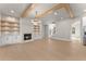 Spacious living room with hardwood floors, built-in shelves, fireplace, and wooden ceiling beams at 3735 Tamiami Trl, Cumming, GA 30041