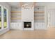 Cozy living room with fireplace, built-in cabinets, and shelving at 3735 Tamiami Trl, Cumming, GA 30041