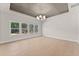 Bright living room with natural light, light hardwood floors, and stylish ceiling at 3735 Tamiami Trl, Cumming, GA 30041