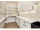 Mudroom featuring white cabinetry, drawers, open shelves and a black sink at 3735 Tamiami Trl, Cumming, GA 30041