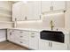 Pantry with white cabinets and drawers, bronze hardware, open shelves, and a black farmhouse sink at 3735 Tamiami Trl, Cumming, GA 30041