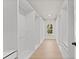 Bright walk-in closet featuring custom shelving and drawers and a light hardwood floor at 3735 Tamiami Trl, Cumming, GA 30041