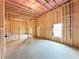 Unfinished basement with exposed framing, insulation, window, and concrete floor, ready for finishing touches at 5342 Legacy Trl, Douglasville, GA 30135
