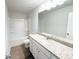 Bathroom features a granite-topped vanity, tub-shower combo, and sleek fixtures for a modern aesthetic at 5342 Legacy Trl, Douglasville, GA 30135