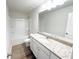 Bathroom features a granite-topped vanity, tub-shower combo, and sleek fixtures for a modern aesthetic at 5342 Legacy Trl, Douglasville, GA 30135