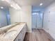 Bathroom featuring granite countertops, double sinks, and a glass-enclosed shower at 5342 Legacy Trl, Douglasville, GA 30135