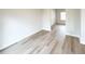 Cozy bedroom featuring hardwood flooring, a bright window, and an open design leading to another room at 5342 Legacy Trl, Douglasville, GA 30135