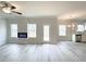 Bright living room featuring a modern fireplace, access to outdoor space and kitchen views at 5342 Legacy Trl, Douglasville, GA 30135