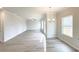 Open living room with modern lighting, ceiling fan and lots of natural light at 5342 Legacy Trl, Douglasville, GA 30135