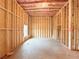 View of unfinished basement with wood framing, insulation and concrete floor at 5342 Legacy Trl, Douglasville, GA 30135