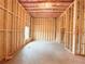 View of unfinished basement with wood framing, insulation and concrete floor at 5342 Legacy Trl, Douglasville, GA 30135