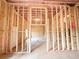 View of unfinished basement with wood framing, insulation and concrete floor at 5342 Legacy Trl, Douglasville, GA 30135