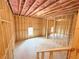 View of unfinished basement with wood framing, insulation and concrete floor at 5342 Legacy Trl, Douglasville, GA 30135